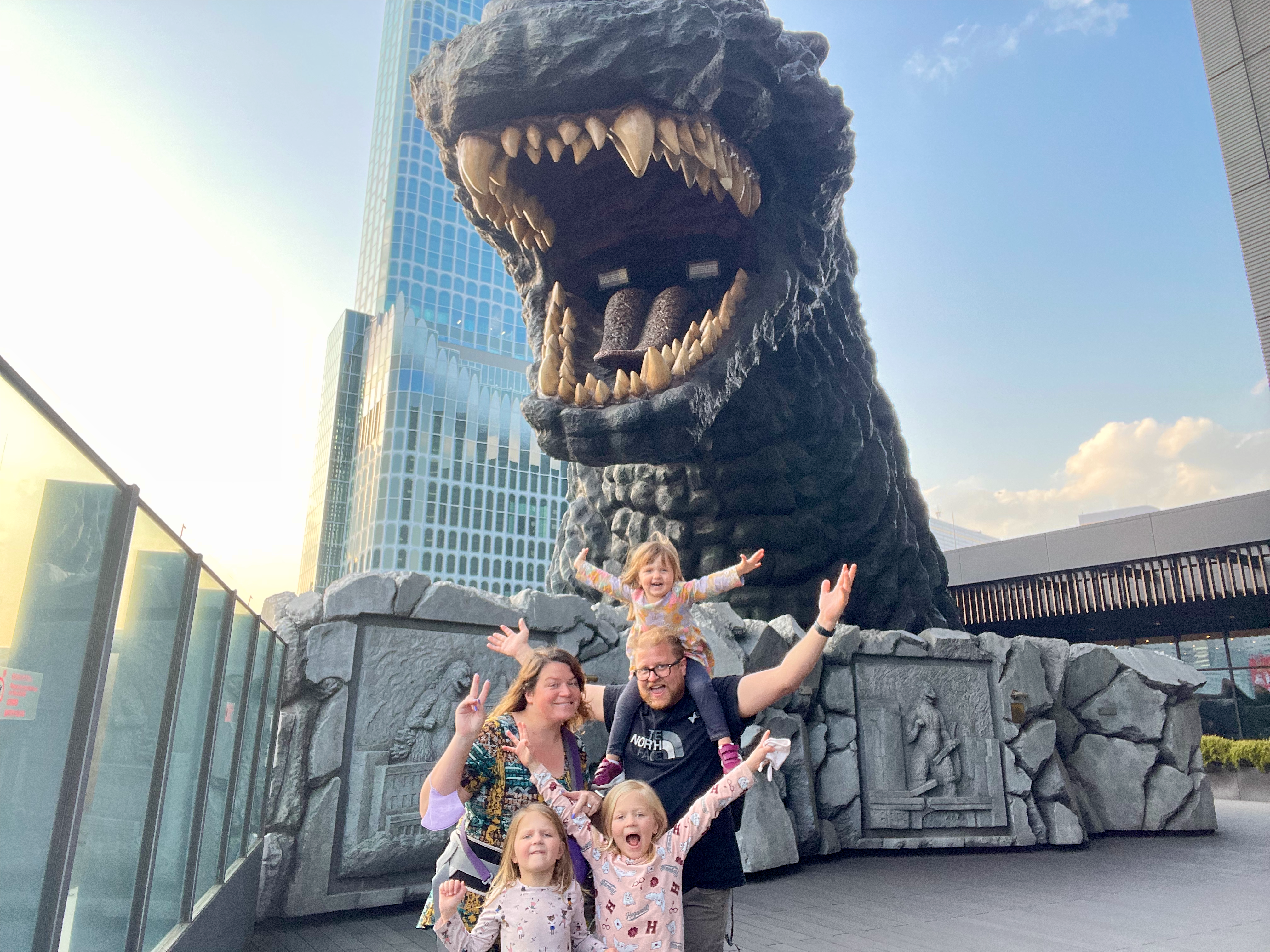 The Clarkson family standing beneath the Godzilla head at Hotel Gracery Shinjuku Tokyo March 2023
